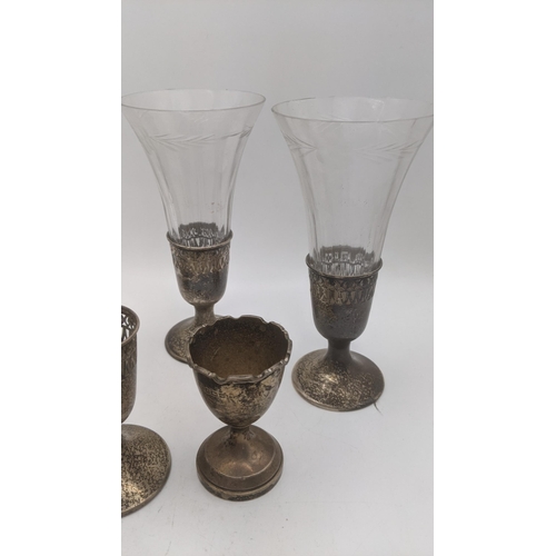 118 - Three sterling silver cut glass vases, along with one extra base, along with a silver eggcup, total ... 