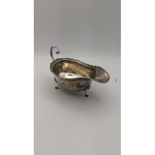 125 - An Adie Brothers silver sauceboat on three feet hallmarked Birmingham 1933, 126.2g Location:R2.1
If ... 