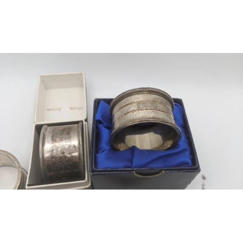 132 - Seven silver napkin rings, all bearing different hallmarks and designs, total weight 185.7g Location... 