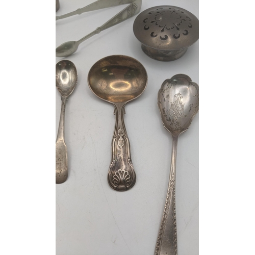 142 - A group of mixed silver to include a tea caddy spoon hallmarked London 1826, along with a pair of su... 