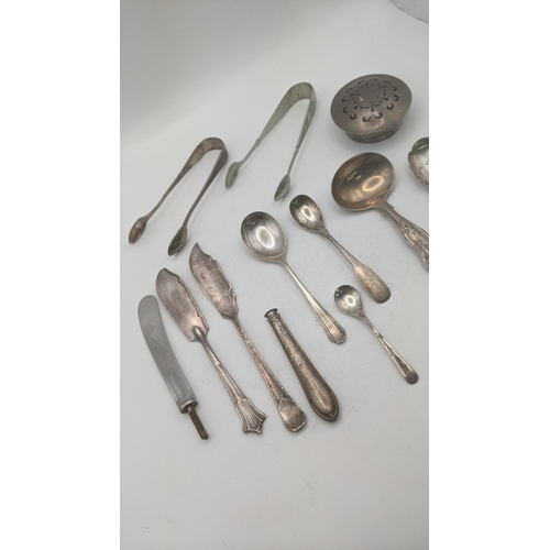 142 - A group of mixed silver to include a tea caddy spoon hallmarked London 1826, along with a pair of su... 