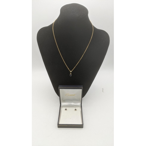 151 - A two piece blue sapphire and 9ct yellow gold suite to include an oval cut blue sapphire pendant on ... 