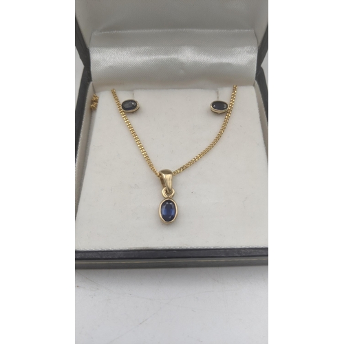 151 - A two piece blue sapphire and 9ct yellow gold suite to include an oval cut blue sapphire pendant on ... 