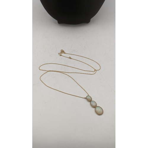 155 - A 9ct gold necklace with a three stone opal pendant mounted in 9ct yellow gold 3.1g A/F Location:CAB... 