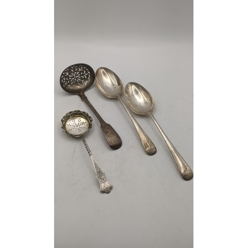 163 - Silver to include two sugar sifters and a pair of Kemp Brothers table spoons, hallmarked London 1935... 