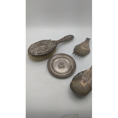 170 - Silver and white metal to include a floral embossed hand brush A/F, together with white metal Ethiop... 