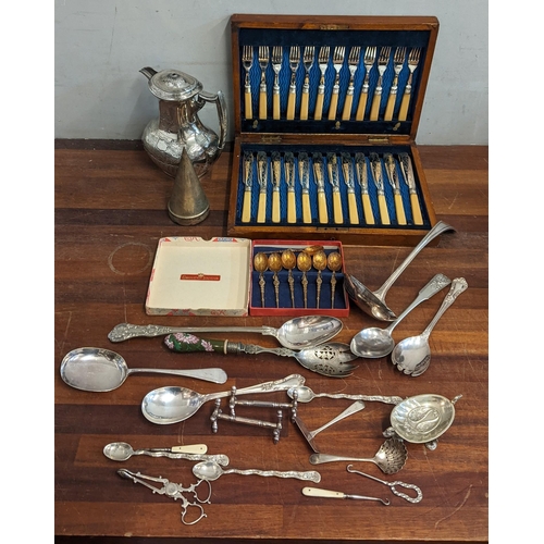 249 - A collection of silver plate to include a boxed canteen of cutlery, an embroidered teapot, a box of ... 