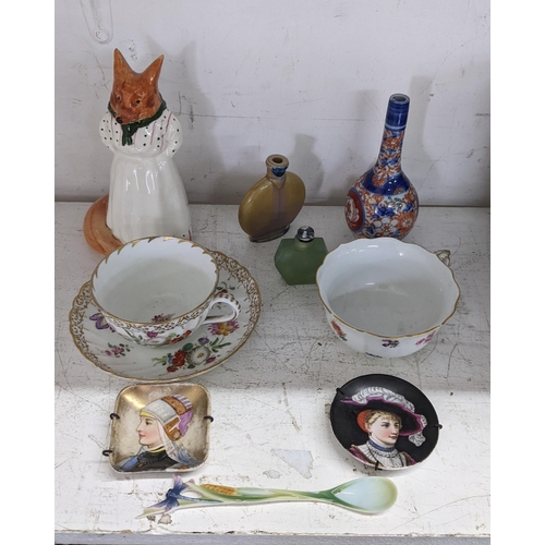 252 - A collection of continental and Japanese ceramics to include a Meissen teacup, a Chinese snuff bottl... 