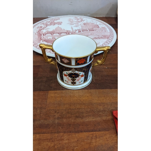 256 - Ceramics to include a Royal Crown Derby twin handled mug, a Delft charger, a Spode cake plate and a ... 