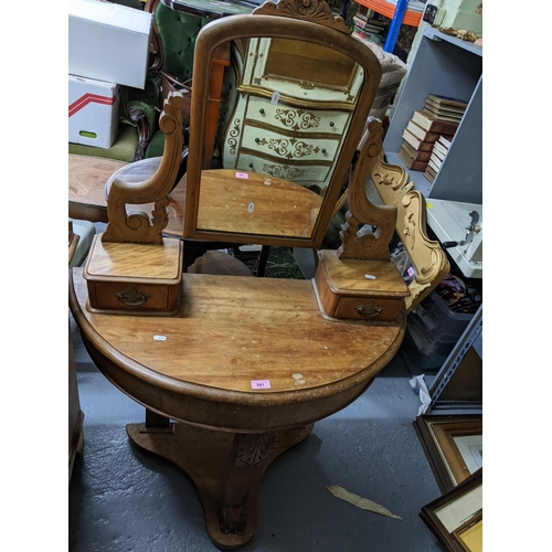 261 - A walnut Duchess dressing table with swing mirror above two glove drawers with carved decoration on ... 