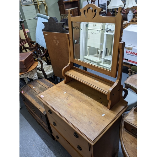 262 - Late Victorian pine dressing chest, swing mirror above open shelf, base with three graduated drawers... 