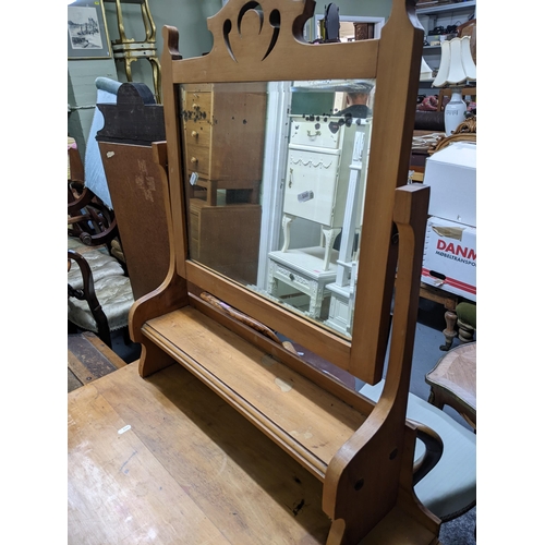 262 - Late Victorian pine dressing chest, swing mirror above open shelf, base with three graduated drawers... 