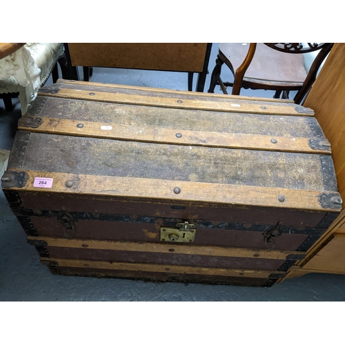 264 - A Victorian domed topped trunk, cloth clad panels, wooden strips with studwork and iron strapwork, a... 