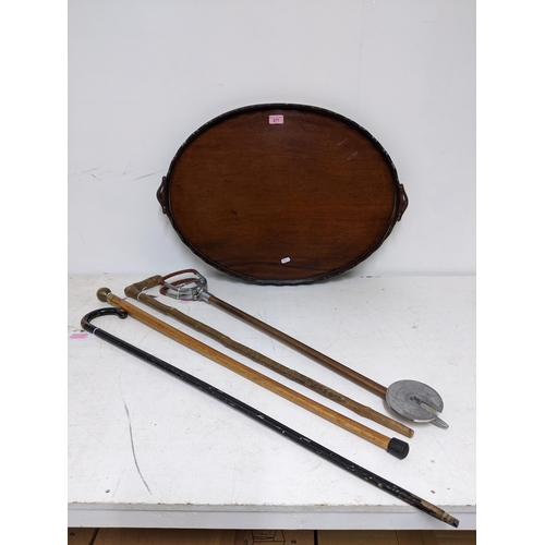 277 - A Victorian mahogany oval galleried tray with twin carrying handles, a shooting stick, walking cane ... 