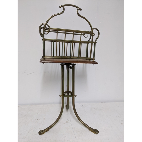 278 - A Victorian brass and oak magazine stand with swivel top, stamped to mechanism 'Hall BM' standing on... 