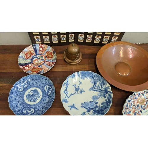 317 - Japanese plates to include Imari and blue and white examples, a Meissen Onion pattern dish, a copper... 