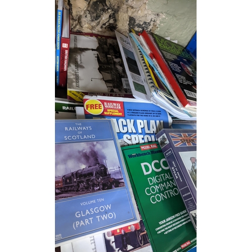 318 - A collection of railway and model railway related publications to include books, magazines VHSs, rec... 