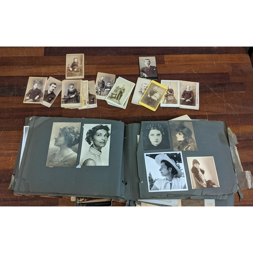 320 - An early 20th century black and white photo album, along with some Victorian photograph cards Locati... 