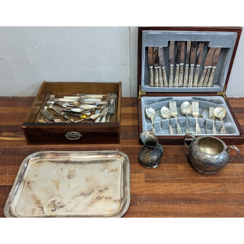 322 - A collection of silver plated items to include a boxed canteen of cutlery, mixed flatware, and souve... 