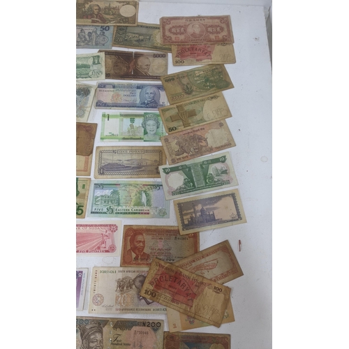 90 - Bank notes from around the world to include examples from China, France, Brazil, South Africa and ot... 