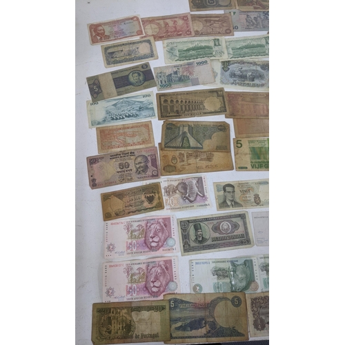 90 - Bank notes from around the world to include examples from China, France, Brazil, South Africa and ot... 