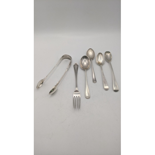 99 - Silver to include a pair of sugar tongs, hallmarked London 1879 together with a fork and a group of ... 