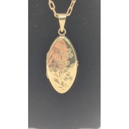 10 - A part 9ct gold locket pendant with a floral engraved design, 8g, on a 9ct gold necklace, 6.9g
Locat... 