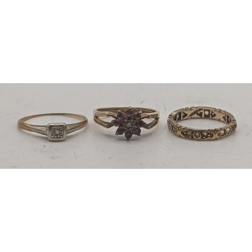 11 - Three gold ladies rings to include a 9ct gold example set with ruby pink coloured stones, together w... 