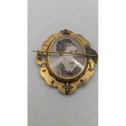 18 - A Victorian gold plated mourning brooch, together with a red and green moss agate and cabochon mount... 