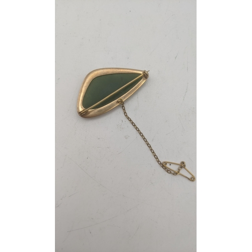 21 - A jadeite pendant in a 9ct gold mount brooch, with safety chain
Location:
If there is no condition r... 