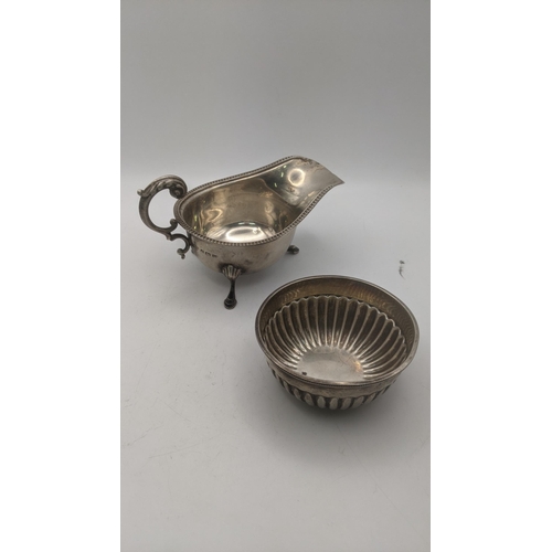 25 - Silver to include a Mappin and Webb bowl, together with a sauceboat on three feet, total weight 171.... 