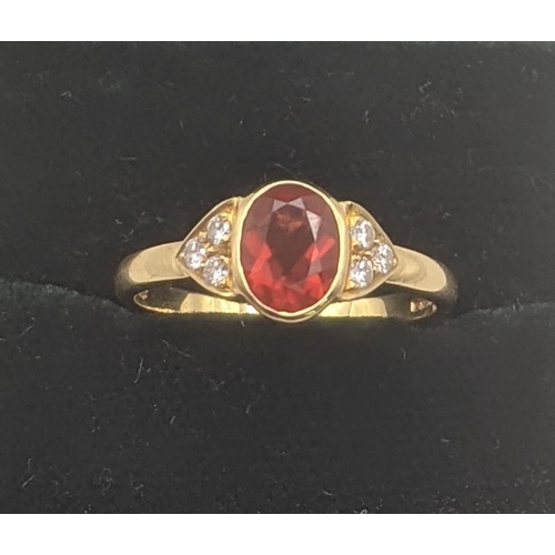 42 - An 18ct yellow gold orange stone and six diamond ring, central oval cut orange stone and shoulders s... 