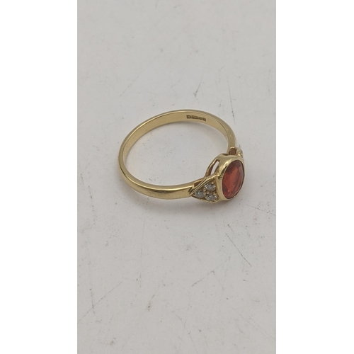 42 - An 18ct yellow gold orange stone and six diamond ring, central oval cut orange stone and shoulders s... 