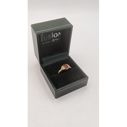 42 - An 18ct yellow gold orange stone and six diamond ring, central oval cut orange stone and shoulders s... 