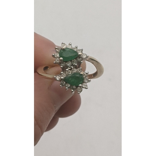 44 - Emerald and diamond pear shaped emeralds surrounded by 24 small brilliant cut diamonds in a 9ct whit... 