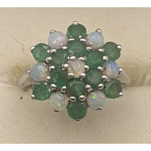 45 - 12 emerald and seven opal cluster flower head ring in a 9ct white gold claw setting and shank, size ... 