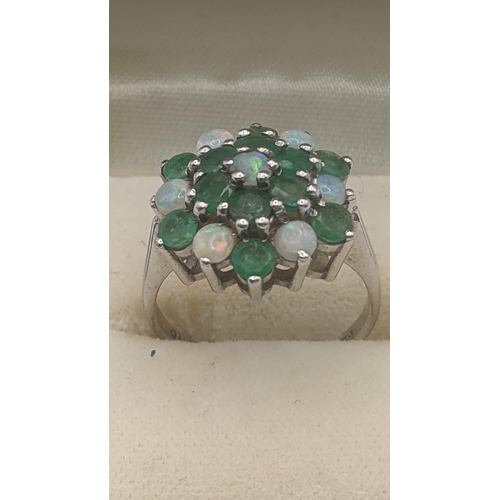 45 - 12 emerald and seven opal cluster flower head ring in a 9ct white gold claw setting and shank, size ... 