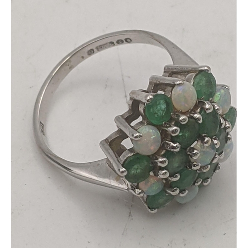 45 - 12 emerald and seven opal cluster flower head ring in a 9ct white gold claw setting and shank, size ... 