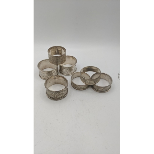 48 - Silver napkin rings of various examples to include a pair of floral engraved napkin rings, hallmarke... 