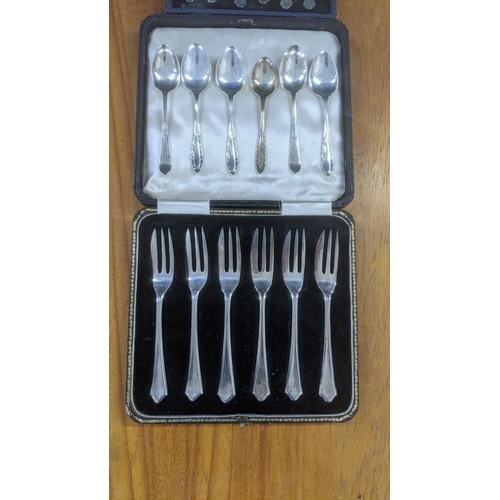 49 - Silver cutlery to include a set of six cake forks, in a fitted case, along with a variety of teaspoo... 