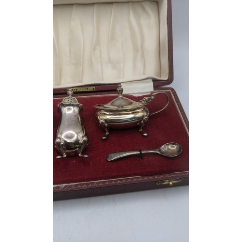 56 - A Barker Ellis Silver Co three piece condiment set to include salts, mustard pot and pepper pot, hav... 