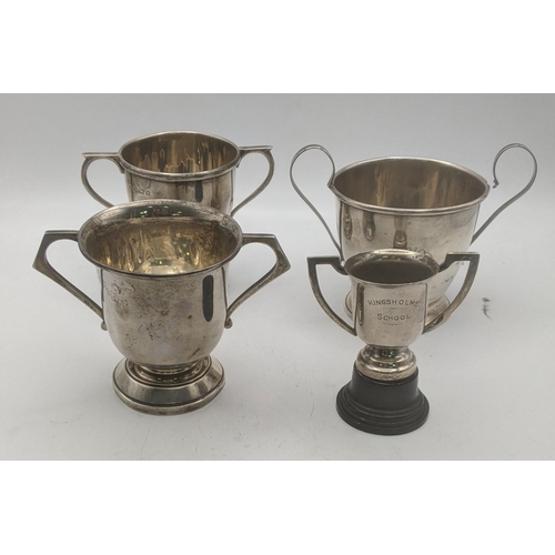 59 - Four silver trophy cups to include one example, initials Kingsholme school on the base together with... 