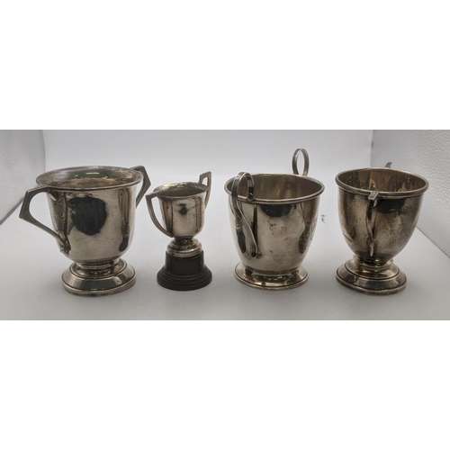 59 - Four silver trophy cups to include one example, initials Kingsholme school on the base together with... 