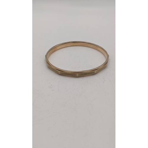 6 - A 9ct gold bangle having a faceted ornate design, 9.7g, 82.7mm in diameter
Location:
If there is no ... 