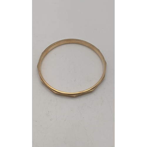 6 - A 9ct gold bangle having a faceted ornate design, 9.7g, 82.7mm in diameter
Location:
If there is no ... 