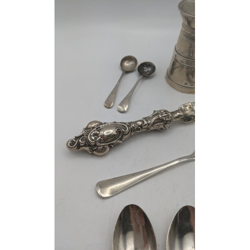 65 - Silver items to include a pepper grinder hallmarked Birmingham 1907, together with a pir of sugar to... 