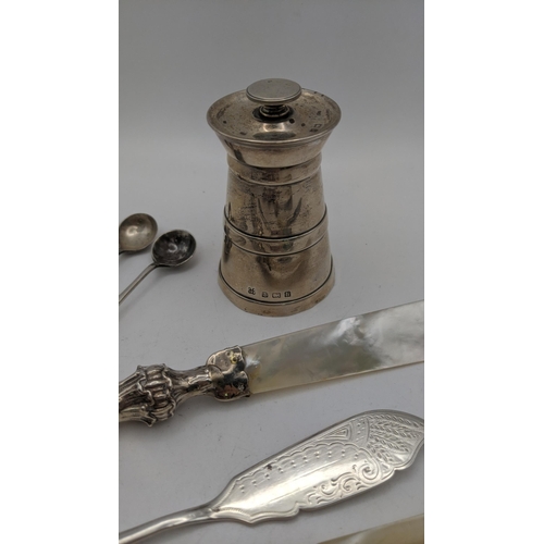 65 - Silver items to include a pepper grinder hallmarked Birmingham 1907, together with a pir of sugar to... 