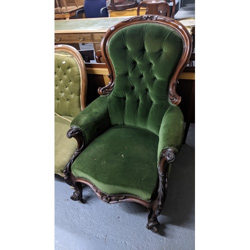 263 - A Victorian carved mahogany upholstered armchair with scrolled leaf relief decoration, button back u... 