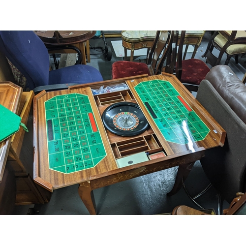 294 - A Sorrento marquetry inlaid games table, with a removeable top and interchangeable gaming boards Loc... 