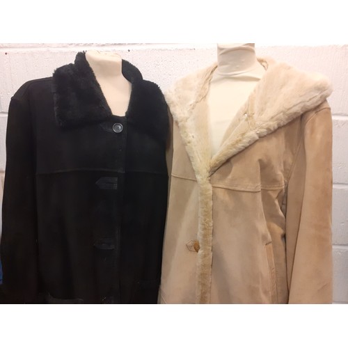 62 - Dennis Basso- Two ladies sheepskin coats comprising a black example (2 front buttons missing) size X... 